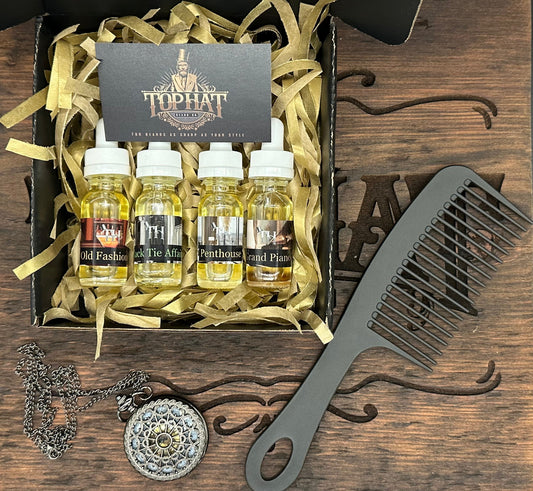 TopHat beard oil sample bottles in a gift box beside a comb and pocket watch on a wooden surface.TopHat beard oil sample bottles in a gift box beside a comb and pocket watch on a wooden surface.